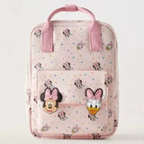 Pink backpack with cartoon character designs on a light gray background